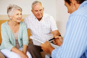 elderly couple talking to an insurance broker about retirement and life insurance